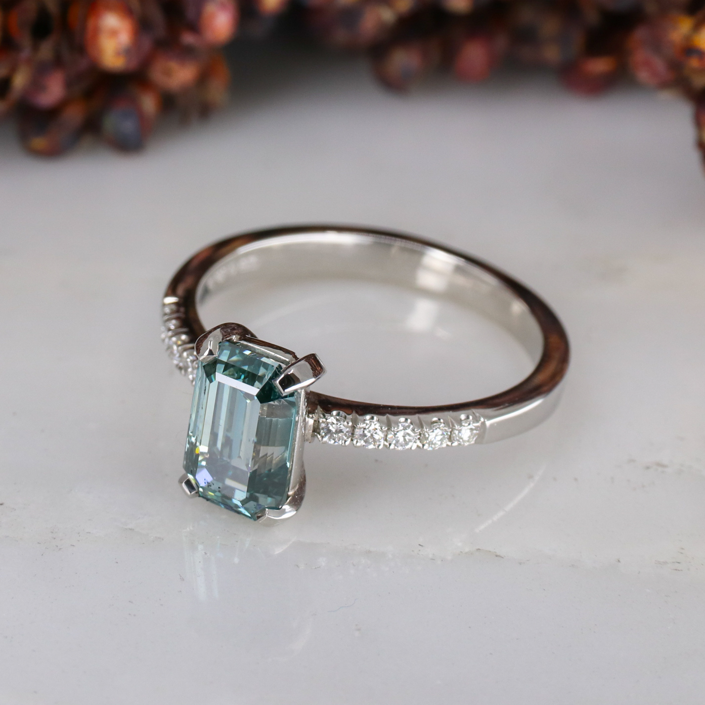 Platinum emerald cut blue diamond rise ring with white diamond ...